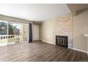 Bright living room with wood flooring, balcony access and a cozy fireplace at 50 S Boulder Cir # 5022, Boulder, CO 80303