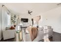 Bright living room with hardwood floors, neutral paint, stylish furniture, and abundant natural light at 3549 Swabuck Pl, Castle Rock, CO 80109