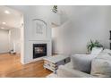 Living room with fireplace, hardwood floors, and comfortable seating at 12910 W Burgundy Dr, Littleton, CO 80127