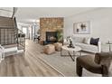 Spacious living room with stone fireplace, wood floors, and open floor plan at 19726 Applewood Ct, Parker, CO 80138