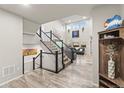 Bright entryway with staircase leads to an open floor plan living area at 17880 W 94Th Dr, Arvada, CO 80007