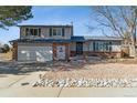 Charming two-story home with a brick and siding facade, showcasing a well-maintained front yard and attached garage at 11231 Clermont Dr, Thornton, CO 80233