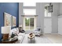 Inviting living room featuring soaring ceilings, large windows, and stylish furnishings at 7700 Bison Ct, Littleton, CO 80125