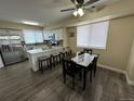 Modern kitchen with a breakfast bar, dining area, stainless steel appliances, and light wood flooring at 12036 Monaco St, Brighton, CO 80602