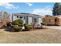 Quaint one-story house with light blue siding, front yard landscaping, and a bright, sunny sky at 1040 Florence St, Aurora, CO 80010