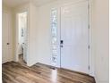 Inviting entryway with wood-look flooring and a decorative stained-glass sidelight at 9466 Quintero St, Commerce City, CO 80022
