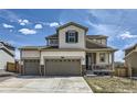 Charming two-story home with a three-car garage and a welcoming front porch at 9466 Quintero St, Commerce City, CO 80022