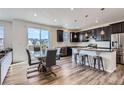 Eat-in kitchen with an island, stainless appliances, and a dining table at 9466 Quintero St, Commerce City, CO 80022