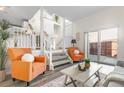 Bright living room featuring modern decor and a sliding door to the outdoor patio at 1315 Estes St # 13C, Denver, CO 80215