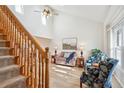 Bright living room with soaring ceilings, hardwood floors, a staircase, and comfortable seating at 5733 S Killarney Way, Centennial, CO 80015