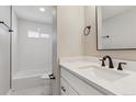 Updated bathroom with white vanity and a bathtub at 9525 Damon Dr, Northglenn, CO 80260