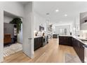 Modern kitchen featuring stainless appliances, white cabinets and hard wood floors, perfect for cooking and entertaining at 2550 Lawrence St # Rb308, Denver, CO 80205
