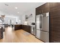 Modern kitchen featuring stainless steel appliances, white subway tile, and hardwood floors at 2550 Lawrence St # Rb308, Denver, CO 80205