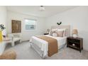 Cozy bedroom with natural light, neutral color palette, and comfortable furnishings at 11586 Chase Way, Westminster, CO 80020