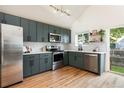 Modern kitchen with stainless steel appliances, sleek cabinetry, and butcher block countertops at 11586 Chase Way, Westminster, CO 80020