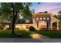 Charming home featuring a stone pathway, manicured lawn, and a blend of stone and siding exterior details at 2 University Ln, Greenwood Village, CO 80121