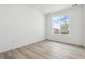 Bright, minimalist bedroom with large window and modern light wood flooring at 19080 E 96Th Pl, Commerce City, CO 80022