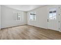 Bright living room featuring light hardwood floors and neutral walls at 3242 Boral Owl Dr, Brighton, CO 80601