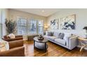 Cozy living room featuring hardwood floors, comfortable seating, and lots of natural light at 16364 Flintlock Ct, Parker, CO 80134