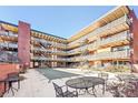 View of the courtyard in a brick building with multiple stories and staircases at 655 N Pearl St # 108, Denver, CO 80203