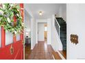 Welcoming foyer with tile floors, staircase, and a glimpse into the adjacent living spaces at 6984 E Montana Pl, Denver, CO 80224