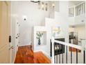 Bright foyer with hardwood floors, a modern fireplace, and an open staircase leading to the upper level at 7777 E 23Rd Ave # 1401, Denver, CO 80238