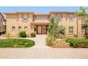 A charming townhome featuring a tile roof, neutral trim, and beautiful front yard landscaping at 7777 E 23Rd Ave # 1401, Denver, CO 80238