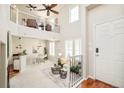 Sunlit living area with soaring ceilings, a cozy fireplace, and an open layout connecting to the dining space at 7777 E 23Rd Ave # 1401, Denver, CO 80238