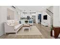 Bright and airy living room with white sofa and hardwood floors at 3955 W 13Th Ave, Denver, CO 80204