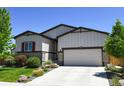 Inviting home exterior with a two-car garage and a well-kept lawn at 6049 Sandstone Cir, Erie, CO 80516
