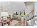 Open-concept living space featuring wood floors, modern decor, and a view of the kitchen at 9275 W Euclid Ave, Littleton, CO 80123