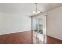 A bright dining room with a sliding door for natural light and patio access at 10792 E Exposition Ave # 353, Aurora, CO 80012