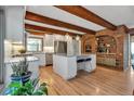 Bright eat-in kitchen featuring white cabinets, stainless appliances, and center island with stone countertops at 1549 Hillside Cir, Sedalia, CO 80135