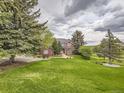 Expansive front yard showcasing lush landscaping and a charming brick home with excellent curb appeal at 18963 E Long Ave, Centennial, CO 80016