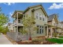 Two-story home with a covered balcony, charming yard, and stylish exterior siding at 1754 W 66Th Ave, Denver, CO 80221