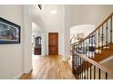 Bright foyer with wood floors, staircase, and views into other rooms at 100 S University Blvd # 11, Denver, CO 80209