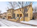 A stunning two-story home featuring a spacious garage and classic design elements and some snow at 100 S University Blvd # 11, Denver, CO 80209