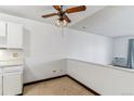Empty dining area featuring neutral walls, a vintage ceiling fan, and tan flooring at 635 S Alton Way # 12C, Denver, CO 80247