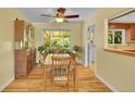 Bright dining room with hardwood floors, a ceiling fan, and a large window overlooking the backyard at 5047 S Mabre Ct, Littleton, CO 80123