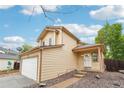 Angle of a two story home with a two car garage, a partial view of the yard, and front entrance at 5262 E Sandpiper Ave, Castle Rock, CO 80104