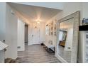 Inviting entryway featuring modern flooring, an oversized mirror, and stylish decor with light colors at 16978 W 87Th Ave, Arvada, CO 80007