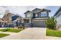 Lovely home with a well-maintained lawn, covered porch, and a two-car attached garage and driveway at 16978 W 87Th Ave, Arvada, CO 80007