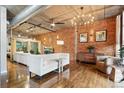 Comfortable living room featuring exposed duct work, brick wall, and wood floors at 1720 Wazee St # 2B, Denver, CO 80202