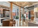 Spacious living room with hardwood floors, exposed ductwork, and a balcony with city views at 1720 Wazee St # 2B, Denver, CO 80202