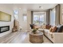 View of a stylish living room featuring neutral decor and a modern fireplace at 6807 Huddersfield Ln, Castle Pines, CO 80108