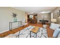 Stylish living room with hardwood floors open to kitchen and modern decor at 1646 S Stuart St, Denver, CO 80219