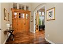 Elegant foyer showcasing hardwood floors, a grand front door, and archway at 14022 E Fair Pl, Centennial, CO 80111