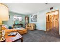Cozy living room with vintage furniture, soft blue walls and a charming grandfather clock at 1922 Graves Ct, Northglenn, CO 80233