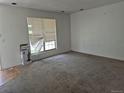View of an expansive living room with plush carpeting and sunlit window, and vacuum present at 18249 E Mexico Pl, Aurora, CO 80017