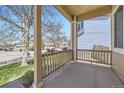 Covered front porch with decorative railing and room to relax on a sunny afternoon at 3744 Gypsum Ct, Superior, CO 80027